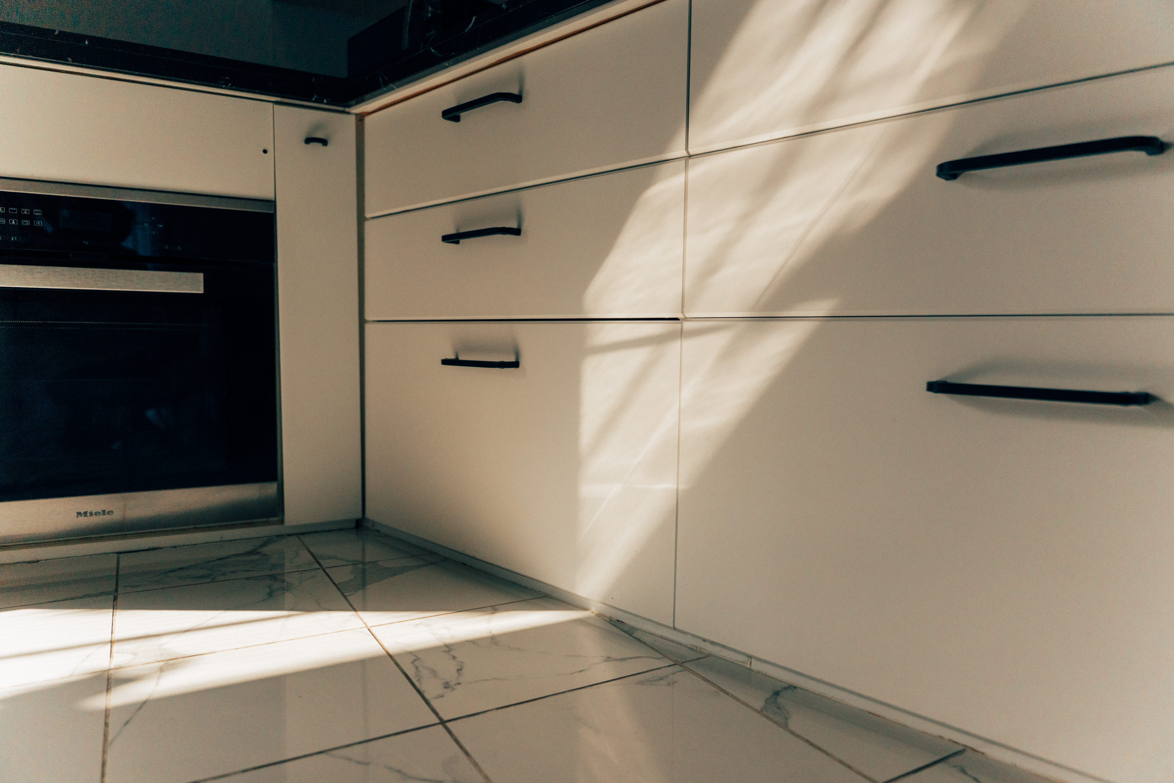 Sunlight across the kitchen cabinetry and built-in oven at One Shibuya Hill