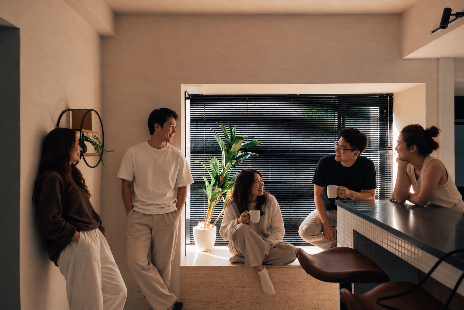 A group of friends gathering around the kitchen at One Shibuya Hill